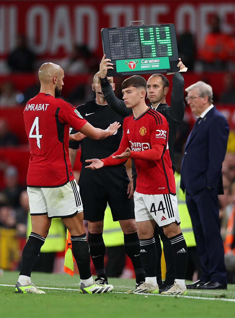 Dan Gore preparing to come on from the touchline during a match.