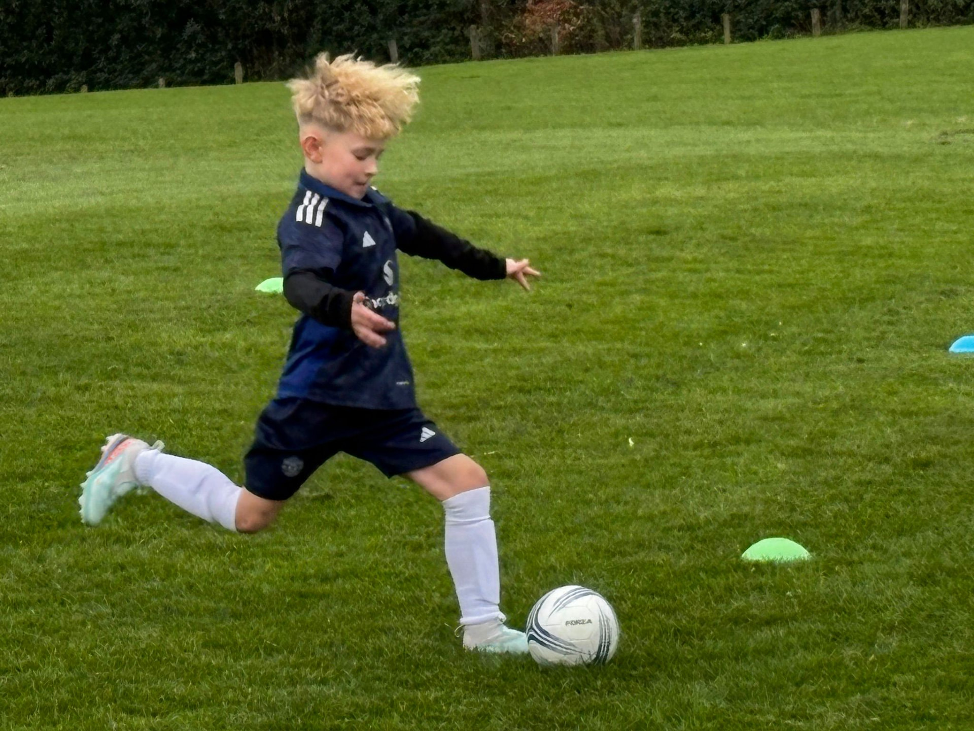 Young player striking the ball during an S&S Coaching session.