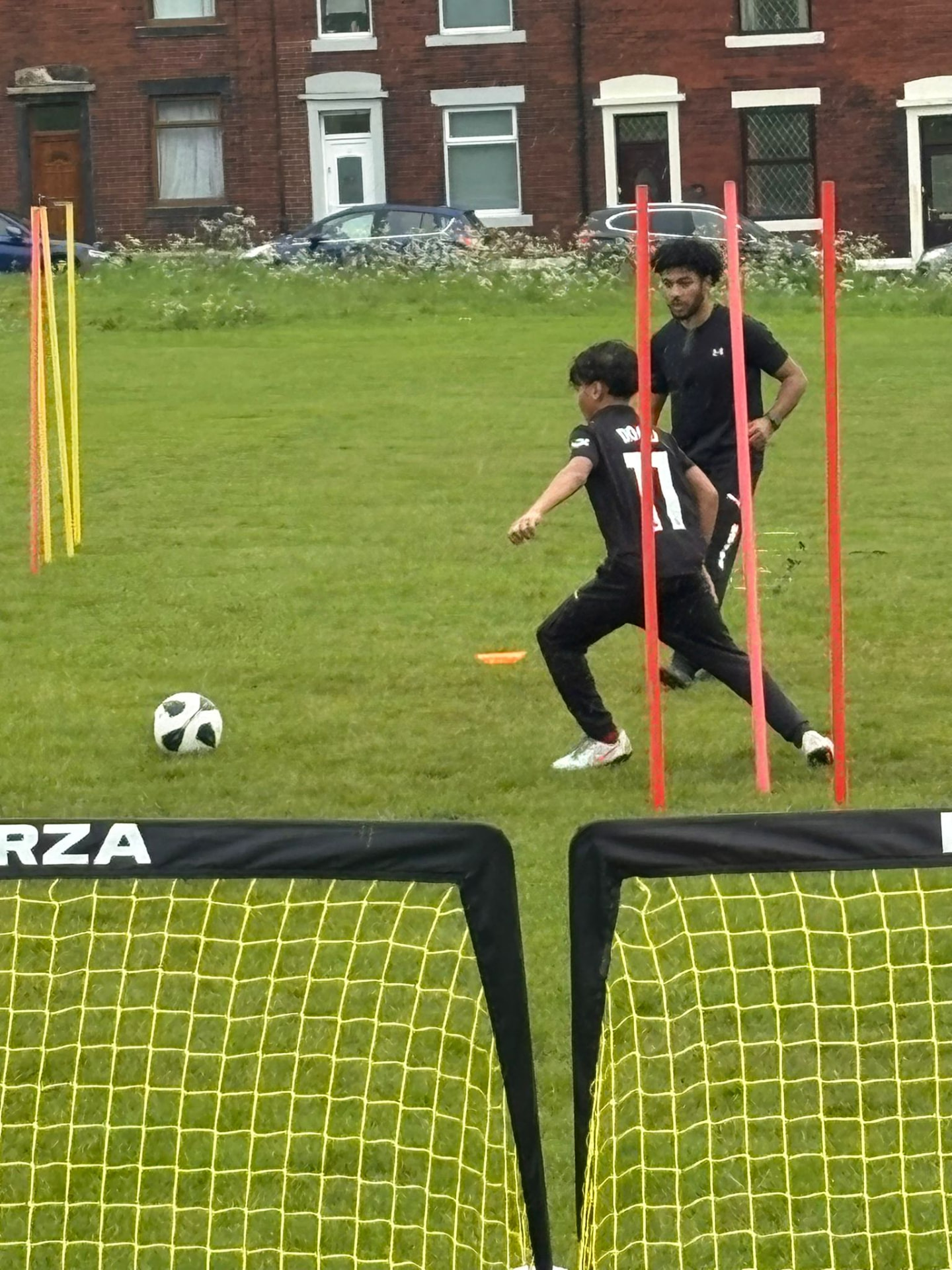 Player working through a passing drill with a coach.